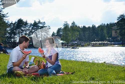 Image of happy young couple having a picnic outdoor