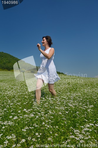 Image of Young happy woman in green field