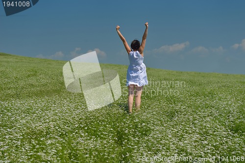 Image of Young happy woman in green field