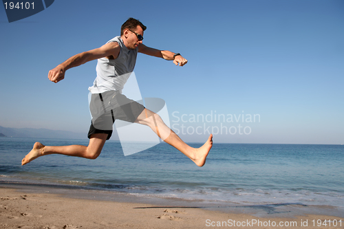 Image of Man jumping on the beach