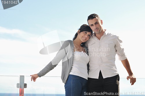 Image of couple relaxing on balcony