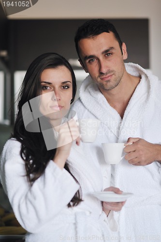 Image of Young love couple taking fresh morning cup of coffee