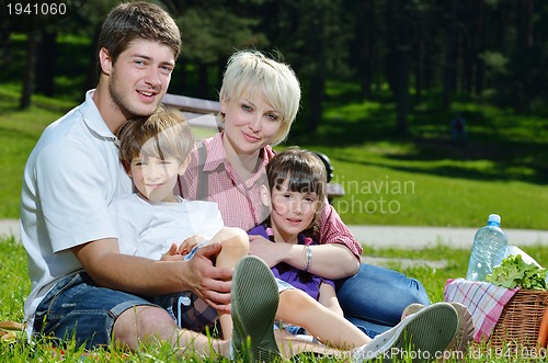 Image of Happy family playing together in a picnic outdoors