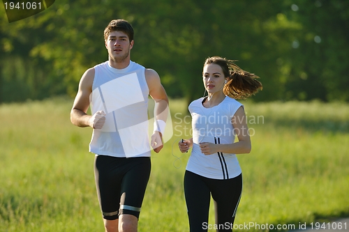 Image of Young couple jogging at morning