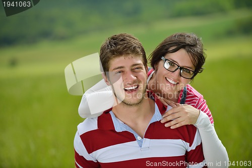 Image of Portrait of romantic young couple smiling together outdoor