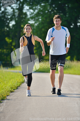 Image of Young couple jogging at morning