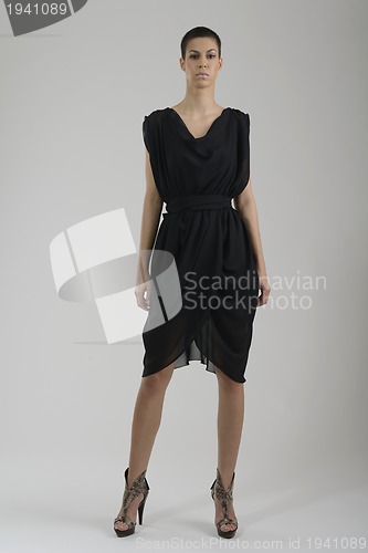 Image of elegant woman in fashionable dress posing in the studio
