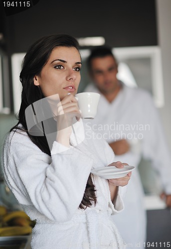 Image of Young love couple taking fresh morning cup of coffee