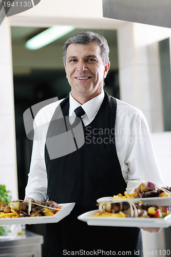 Image of male chef presenting food