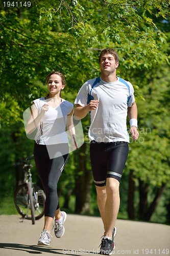 Image of Young couple jogging at morning