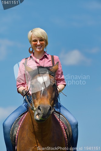 Image of happy woman  on  horse