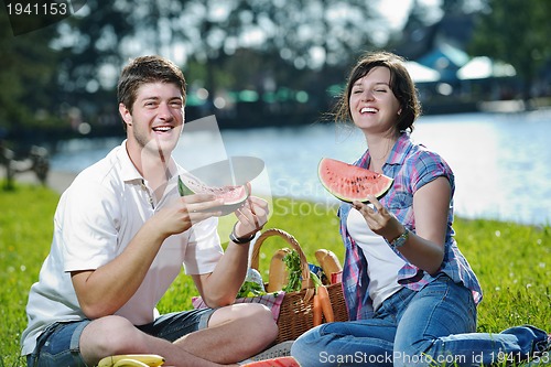 Image of happy young couple having a picnic outdoor