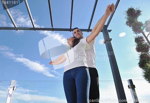 Image of couple relaxing on balcony