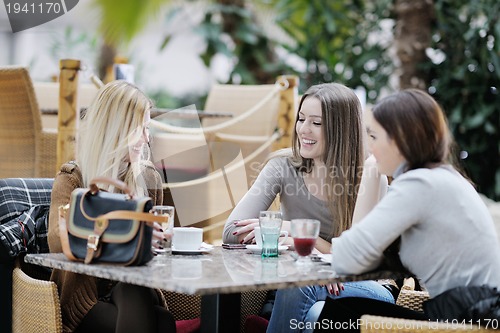 Image of cute smiling women drinking a coffee