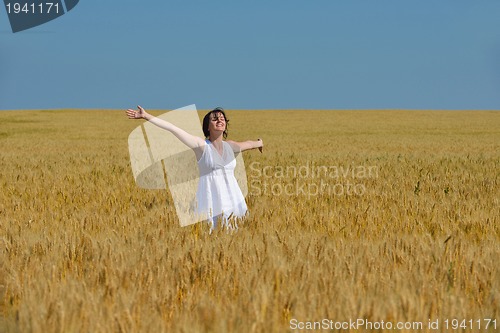 Image of young woman in wheat field at summer