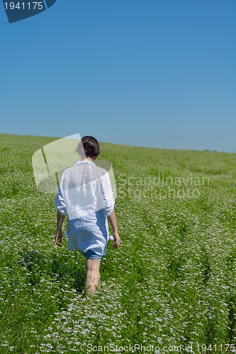 Image of Young happy woman in green field