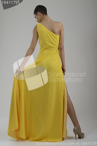 Image of elegant woman in fashionable dress posing in the studio