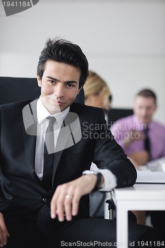 Image of young business man at meeting