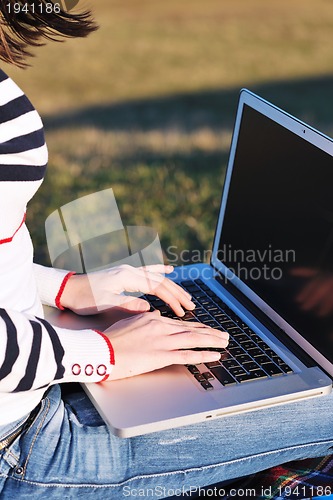 Image of young teen girl work on laptop outdoor