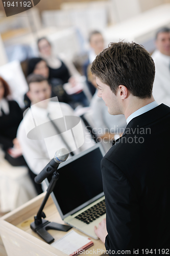 Image of Young  business man giving a presentation on conference