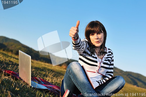 Image of young teen girl work on laptop outdoor