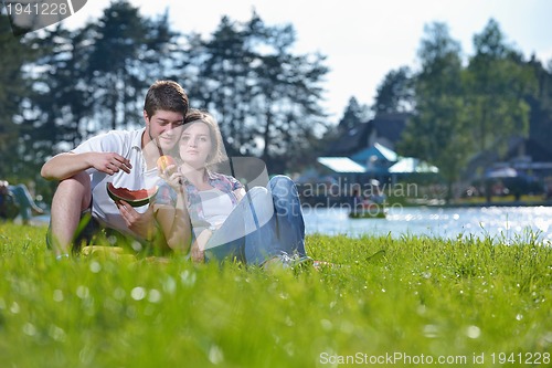 Image of happy young couple having a picnic outdoor