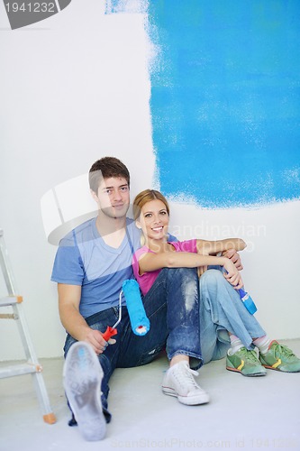 Image of happy young cople relaxing after painting in new home