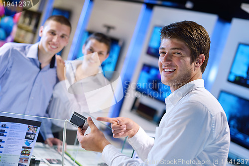 Image of Young couple in consumer electronics store