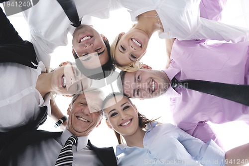 Image of business people with their heads together