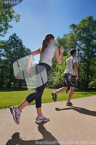 Image of Young couple jogging at morning