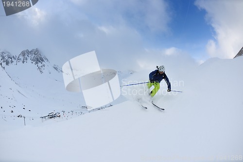 Image of skiing on fresh snow at winter season at beautiful sunny day