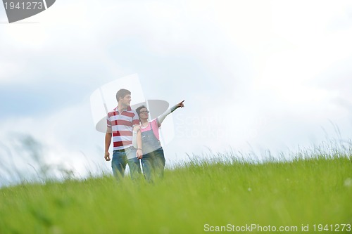 Image of Portrait of romantic young couple smiling together outdoor