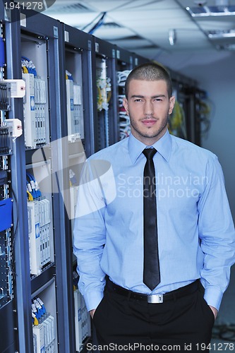 Image of young it engeneer in datacenter server room