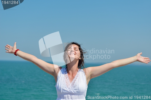 Image of young woman with spreading arms to sky