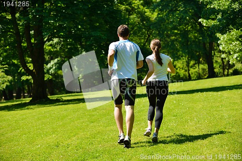 Image of Young couple jogging at morning