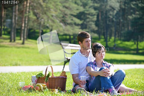 Image of happy young couple having a picnic outdoor