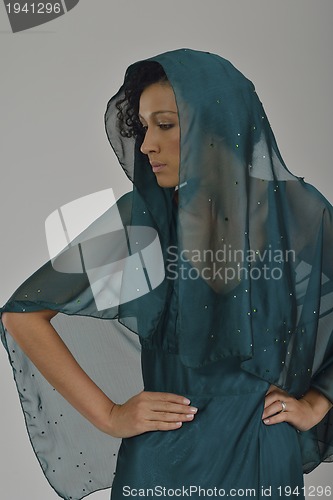 Image of elegant woman in fashionable dress posing in the studio