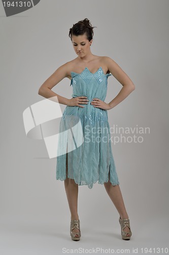 Image of elegant woman in fashionable dress posing in the studio