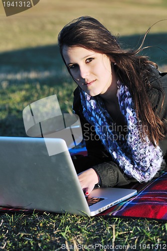 Image of young teen girl work on laptop outdoor
