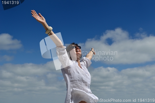 Image of young woman with spreading arms to sky