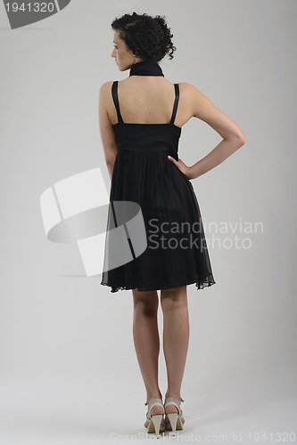 Image of elegant woman in fashionable dress posing in the studio