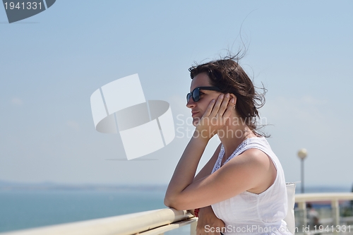 Image of young woman with spreading arms to sky