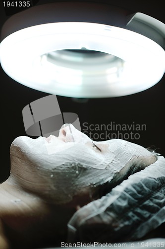 Image of woman with facial mask in cosmetic studio