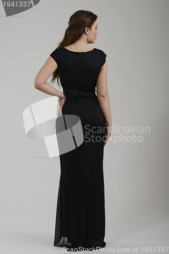Image of elegant woman in fashionable dress posing in the studio