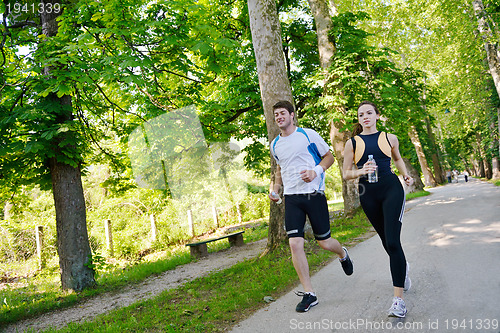 Image of Young couple jogging