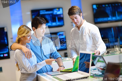 Image of Young couple in consumer electronics store