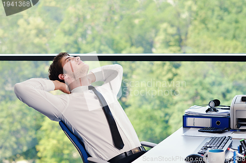 Image of happy young business man at office