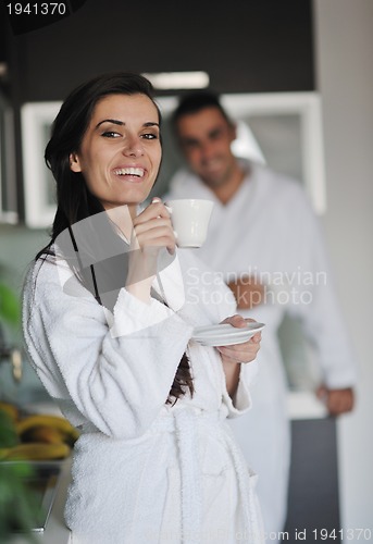 Image of Young love couple taking fresh morning cup of coffee