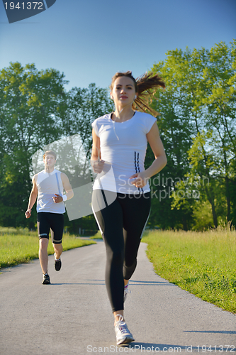 Image of Young couple jogging at morning