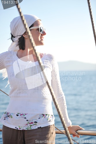 Image of Greek woman on the streets of Oia, Santorini, Greece